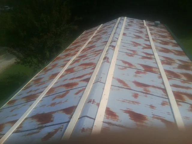 Rusted metal roof panels with new wood purlins before replacement — Storm Damage Roof Repair in Montreat by Roofing Brothers