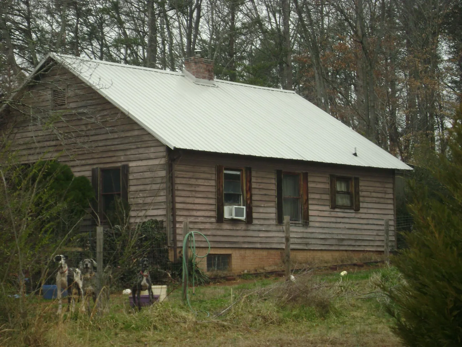 White metal roof on an old wood sided farmhouse, from a Metal Roof Installation job in Montreat